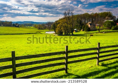 Fence and view of a farm in rural York County, Pennsylvania.