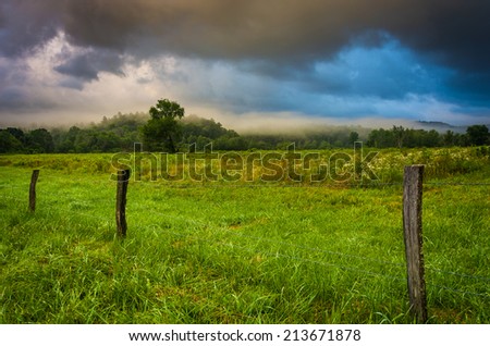 Fence and fog in a field at sunrise, at Cade\'s Cove , Great Smoky Mountains National Park, Tennessee.