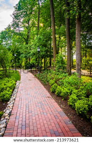 Trees and bushes along a brick path at John Hopkins University in Baltimore, Maryland.