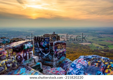 Graffiti covered rocks and overlook of the Cumberland Valley from High Rock, in Pen Mar County Park, Maryland.