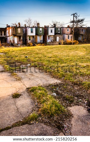 Cracked sidewalk and abandoned row houses in Baltimore, Maryland.