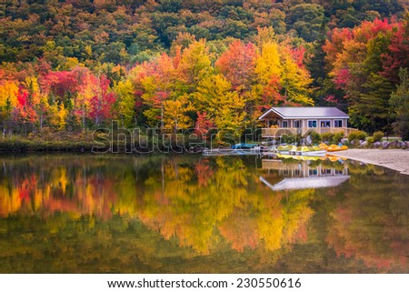 Boathouse and fall colors reflecting in Echo Lake, in Franconia Notch State Park, New Hampshire.