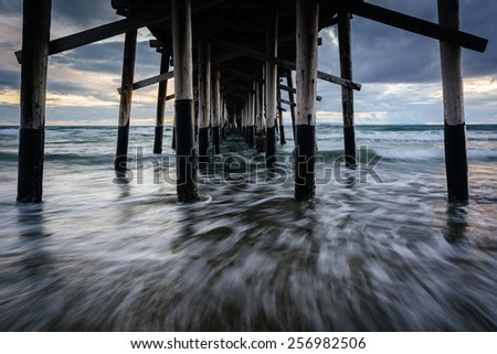 Waves under the pier, in Newport Beach, California.