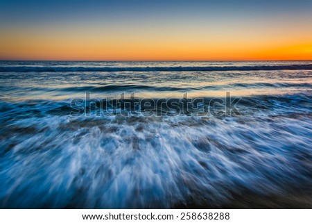 Sunset over waves in the Pacific Ocean, in Santa Monica, California.