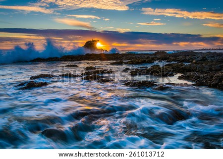 Waves and rocks at sunset, at Little Corona Beach, in Corona del Mar, California.