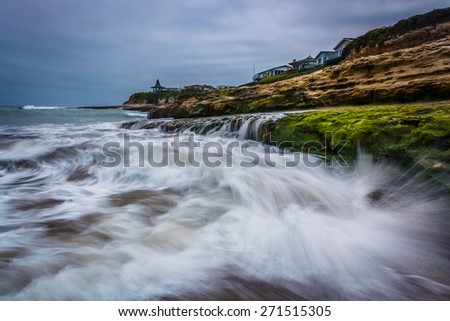 Waves crashing on rocks at Natural Bridges State Beach, in Santa Cruz, California.