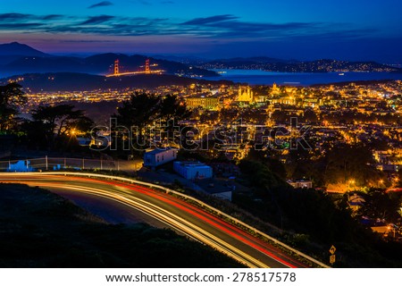 Twin Peaks Boulevard and view of San Francisco at night, from Twin Peaks, in San Francisco, California.