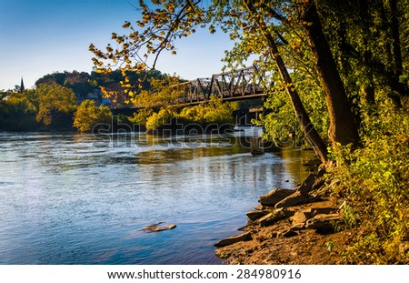 Trees and train bridge over the Potomac River in Harper\'s Ferry, West Virginia.