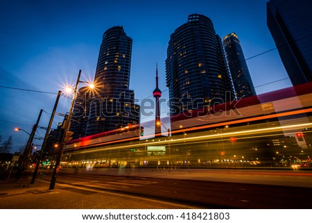 Queens Quay West and modern buildings at night, at the Harbourfront in Toronto, Ontario.