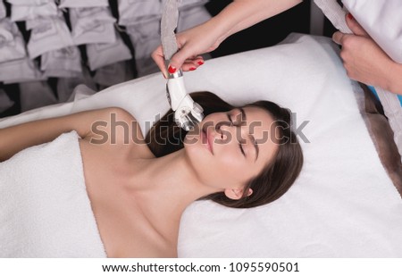 Lymphatic drainage massage LPG apparatus process. Therapist beautician makes a rejuvenating facial massage for the woman in a SPA salon. Beauty and bodycare concept.