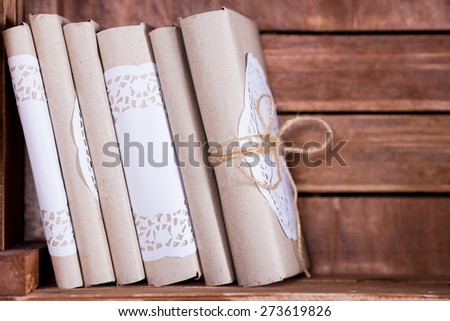 Wood book shelf with old books and candle in rustic style