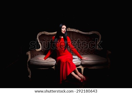 Beautiful woman sitting on antique sofa