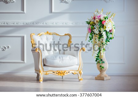 White leather vintage style chair in classical interior room with big window and spring flowers