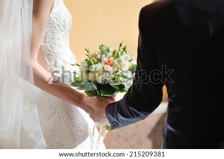 In the hands of the bride and groom wedding bouquet