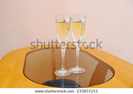 two glasses with champagne standing on the table