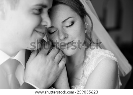Black-and-white portrait of the bride and groom close