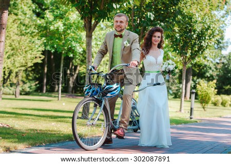 Bride and groom on tandem bike
