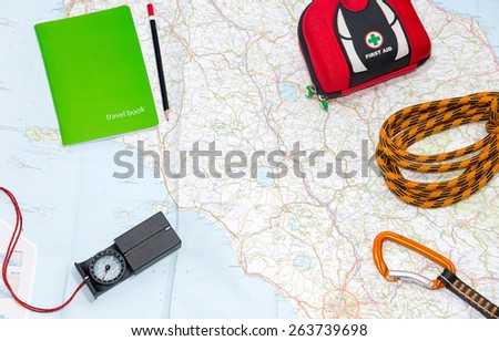 Planning an adventure trip in Italy. Backpacking items laid out on a map to plan a trip