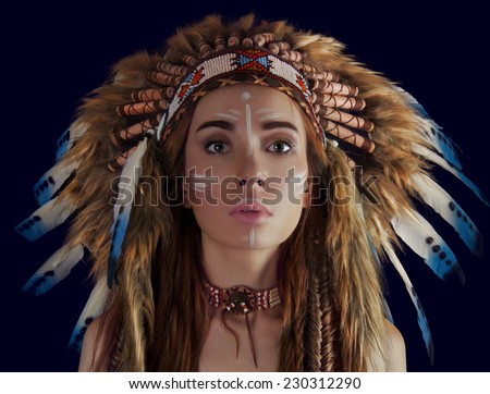 American Indian girl in a headdress of feathers.