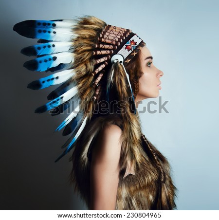 american Indian girl in a headdress of feathers.