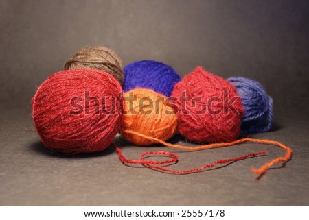 colored balls of threads on a dark background