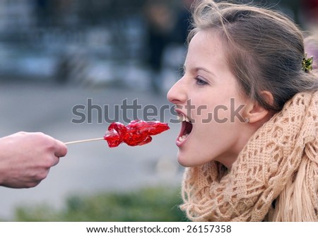portrait of girl with a lollipop on a stick