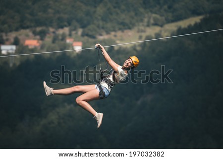 Adult woman on zip line Adult woman on zip line