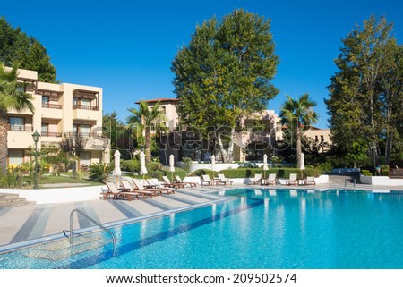 HALKIDIKI, GREECE-JUL 22, 2014: Sunbeds and umbrellas at a luxury hotel.Kallithea summer resort at Kassandra of Halkidiki peninsula in Greece