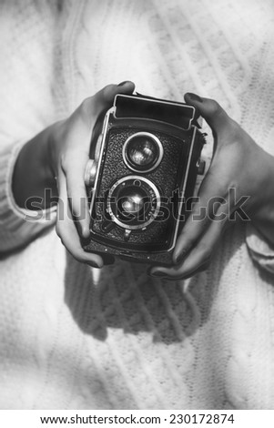 Young woman with a retro camera