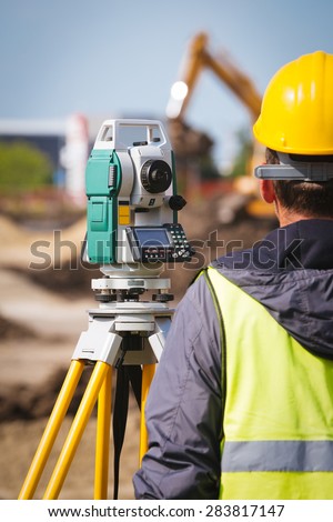 Surveyor engineer worker making measuring with theodolite tool equipment at construction site