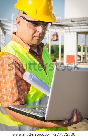Construction Worker Using Laptop