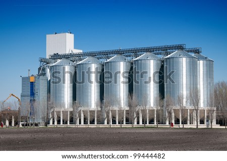 Silver Grain Silos with blue sky in background