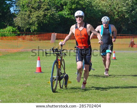 ST NEOTS, CAMBRIDGESHIRE, ENGLAND - JUNE 07, 2015: Triathlon  Men running in to change over.