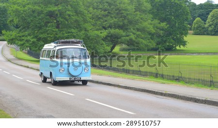 SAFFRON WALDEN, ESSEX, ENGLAND - JUNE 21, 2015: ClassicLight Blue & White Volkswagen Camper Van on country road.
