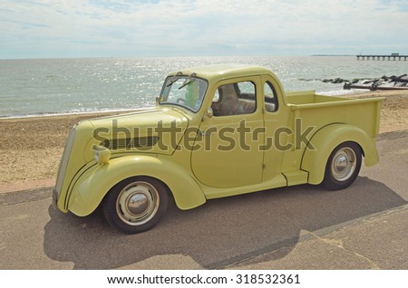 FELIXSTOWE, SUFFOLK, ENGLAND - AUGUST 29, 2015: Classic Light Brown Ford pickup truck on Felixstowe seafront.