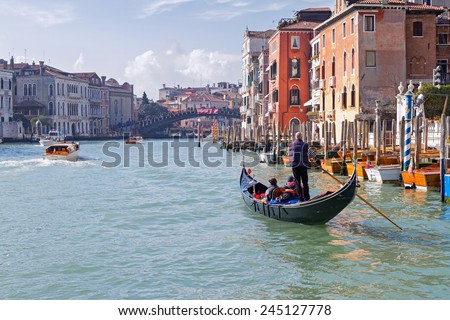 GRAND CANAL, VENICE, ITALY - FEBRUARY 27, 2014: Unidentified person in a gondola on the Grand Canal in Venice, Italy on February 2014.