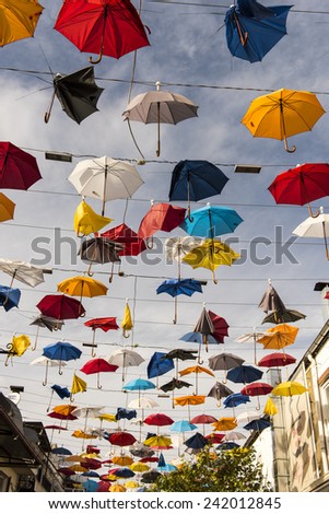 Colourful Colourful umbrellas hanging on the street, broken by wind