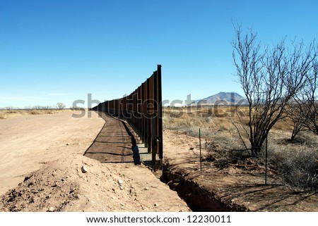 End of U.S.-Mexico border fence under construction in Arizona desert (U.S. to the left, Mexico to the right)