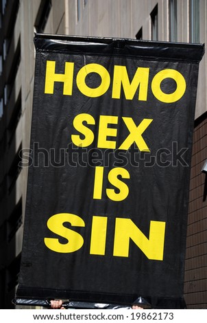 Poster claiming gay sex as sin, held up during a demonstration