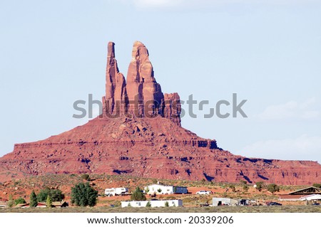 Modest houses below majestic mesa in Monument Valley, Arizona, in Navajo Nation
