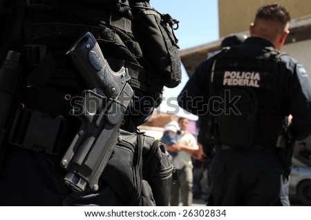 Closeup of a handgun of Mexican federal police forces maintaining order in the violent border city of Ciudad Juarez