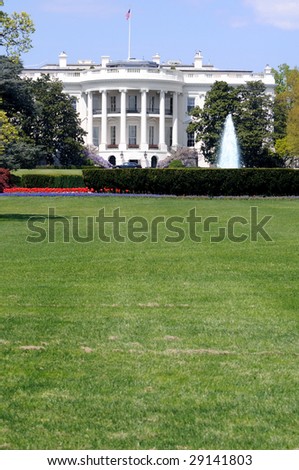 South facade and South lawn of the White House in Washington DC in spring colors, with vertical copyspace on the fresh green lawn