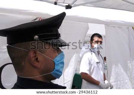 MEXICO CITY - APRIL 29: A police officer wears a face mask as he stands guard at a makeshift clinic on April 29, 2009 in Mexico City. Doctors are trying to detect patients with the Swine Flu.