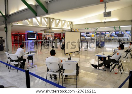 MEXICO CITY - MAY 1: Departing passengers are questioned about their health and screened for fever by officials  at the Benito Juarez Airport on May 1, 2009 in Mexico City.