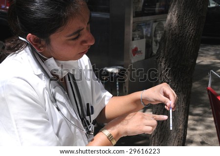 MEXICO CITY - APRIL 30: Close up of a nurse at a mobile clinic on a downtown street examines testing data to detect signs of H1N1 swine flu influenza on April 30, 2009 in Mexico City.