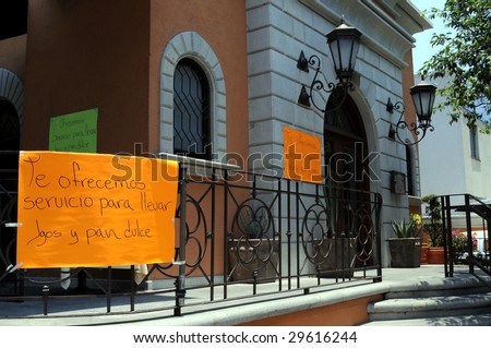 Signs posted outside a restaurant in Mexico City informing that only takeout food is served because of a citywide shutdown imposed (shot April 30, 2009) to combat influenza epidemic.