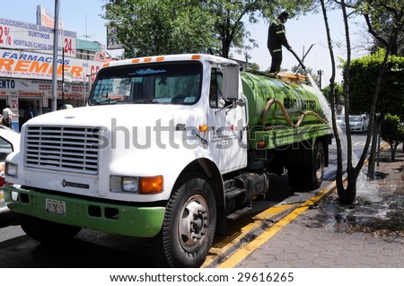 MEXICO CITY - APRIL 28: A water truck washes and cleans the street of Calzada de Tlalpan in front of a hospital in Mexico City, during the outbreak of the flu epidemic on April 28, 2009 in Mexico CIty.