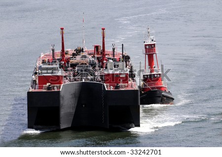 Tug boat towing a huge ship