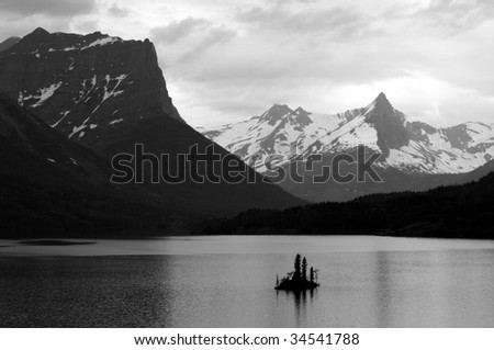 A black and white photo of the Wild Goose Island and Saint Mary Lake in the Glacier National Park in Montana, northwestern USA, shot in early July.