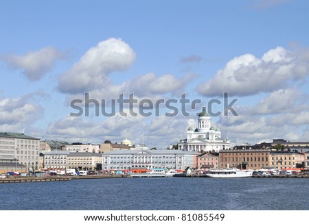 Skyline of downtown Helsinki in the summer, seen from the South Harbor (Etelasatama). Helsinki Cathedral seen towering above the surrounding neoclassical buildings. Market square in the foreground.